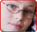 photo: close-up photo of a young girl wearing wireframe glasses